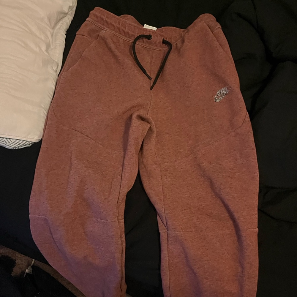 Red Nike tech pants